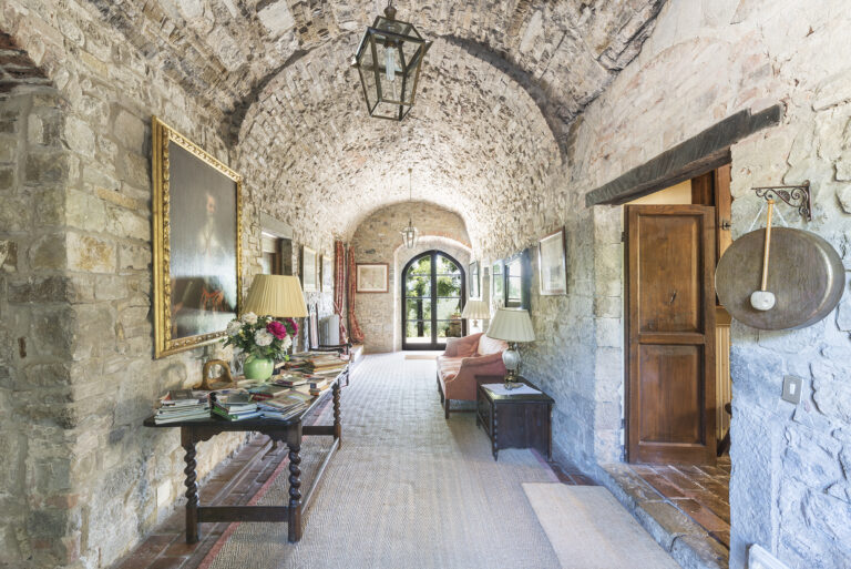 Interior of Tuscan stone villa with antique decor at writers retreat in Italy