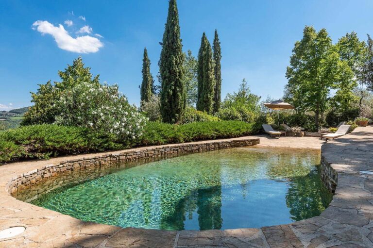 Natural stone swimming pool at luxury writers retreat villa in Tuscany